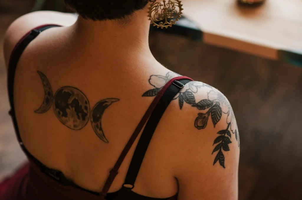 a girl with tattoo on back