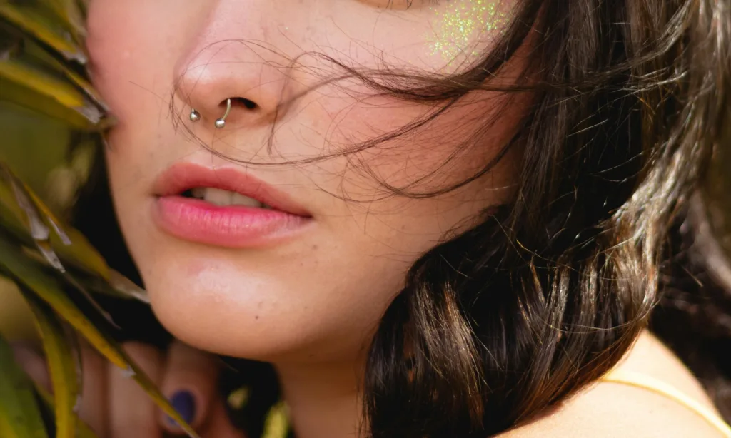 a girl with silver nose piercing