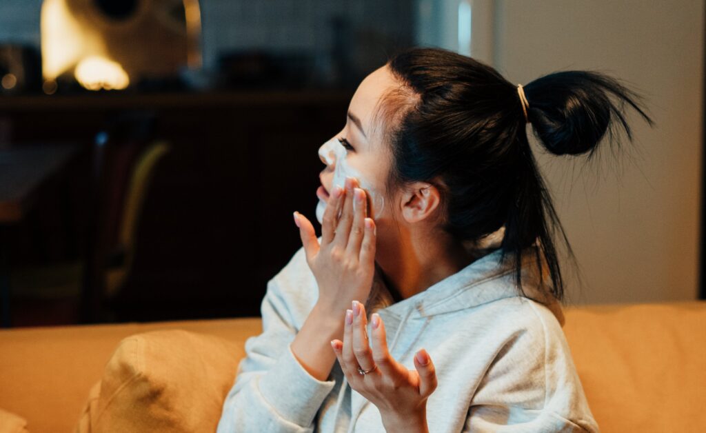 a girl applying skincare